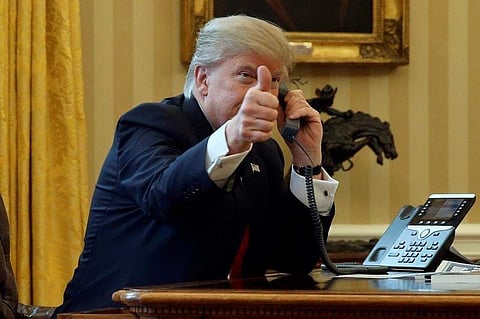 U.S. President Donald Trump gives a thumbs-up to reporters as he waits to speak by phone with the Saudi Arabia's King Salman in the Oval Office at the White House in Washington, U.S. January 29, 2017. REUTERS