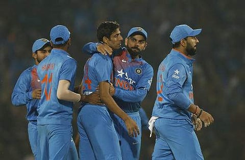 India's Ashish Nehra, third left and captain Virat Kohli, fourth left, celebrate the wicket of England's Jason Roy during their second Twenty20 international cricket match at Vidarbha cricket association stadium in Nagpur. | AP
