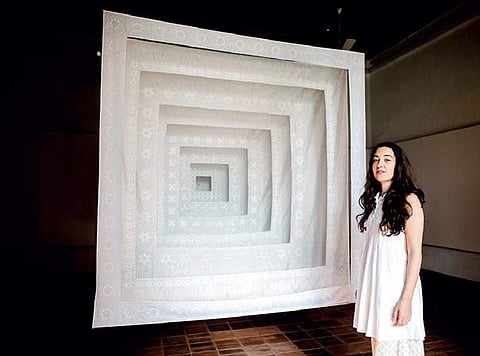 Artist Dana Awartani beside her  installation ‘Love is My Law, Love is My Faith’ at KMB 2016, at David Hall, Fort Kochi