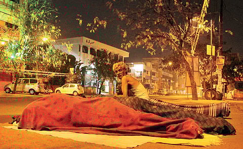 Migrant labourers sleep on pavements at Kaloor with just a blanket to protect them from the elements  Albin Mathew