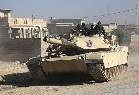 Iraqi special forces soldiers sit on their tank as they pass by the Samah front line neighborhood in Mosul city.(Photo |AP)