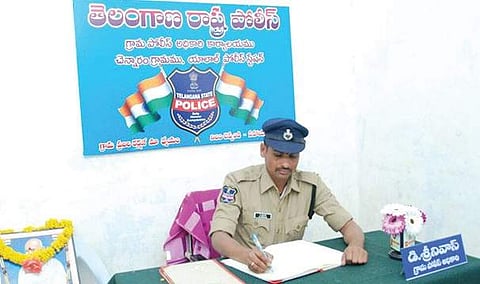 Village Police Officer D Srinivas on work at Chennaram village in Rangareddy  district on Saturday | express photo