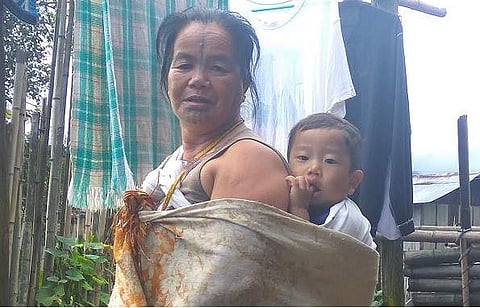 Narang Yamyang, the last woman from Apatani tribe to get a  facial tattoo, with her grandson at their residence in Hong  village in Ziro Valley in Lower Subansiri district of Arunachal  Pradesh on Sunday. | Aishik Chanda