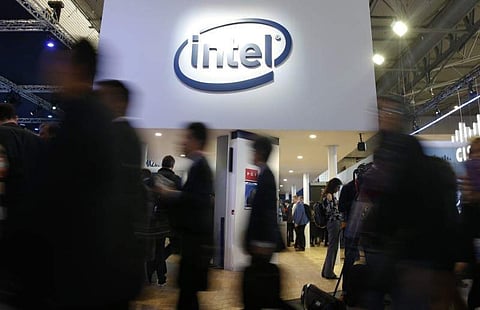 People walk under Intel logo at Mobile World Congress in Barcelona. (Photo | Reuters)