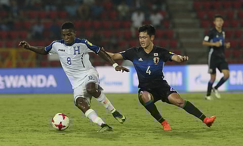 Japanese player Takefusa Kubo, 7, duels for the ball during the FIFA U-17 World Cup match against Honduras in Gauhati, India on Oct.8 , 2017. (Photo | AP)