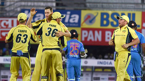 Australian bowler Jason Behrendorff with teammates celebrat after taking the wicket of Indian batsman Rohit Sharma during their second T20 cricket match in Guwahati on Tuesday. (Photo | PTI)