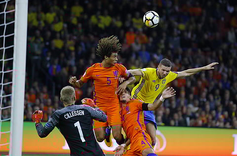 Sweden's Marcus Berg, right, jumps for the ball with Netherland's Daley Blind during a World Cup Group A soccer qualifying match between the Netherlands and Sweden at the ArenA stadium in Amsterdam, Netherlands, Tuesday, Oct. 10, 2017. | AP