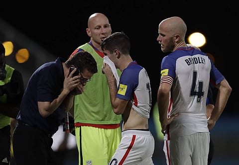 United States' Christian Pulisic, center, and his teammate United States' Michael Bradley, right, walk on the pitch after losing 2-1 against Trinidad and Tobago during a 2018 World Cup qualifying soccer match. | AP