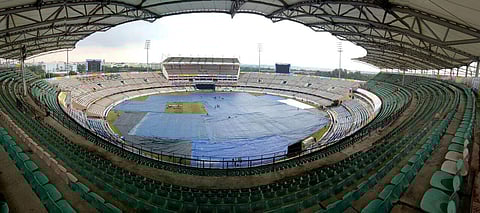 Indian workers covers the pitch with plastic sheets ahead of third Twenty20 match between India and Australia in Hyderabad, India, Thursday, Oct. 12, 2017.| Express / Vinay Madapu
