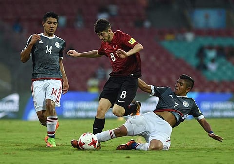 Antonio Galeano (R) of Paraguay and Kerem Kesgin (C) of Turkey vie for the ball during the group stage football match at the FIFA U-17 World Cup in Navi Mumbai. (Photo  |AFP)