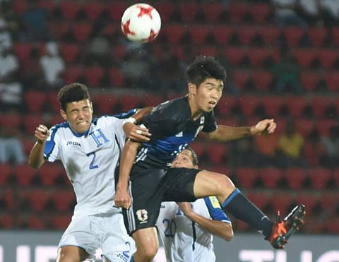 Japan (blue) and Honduras (white) players vie for the ball during FIFA U-17 World Cup India 2017 in Guwahati on Sunday. (Photo | PTI)