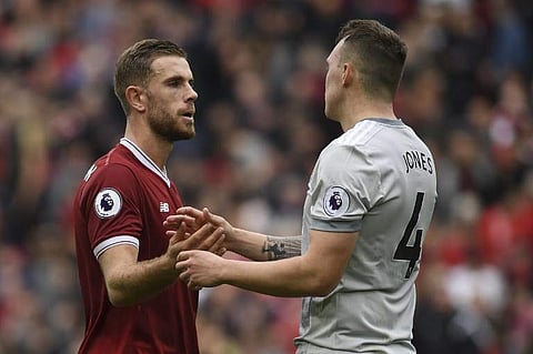 Liverpool's English midfielder Jordan Henderson (L) shakes hands with Manchester United's English defender Phil Jones after the English Premier League football match between Liverpool and Manchester United.|AFP