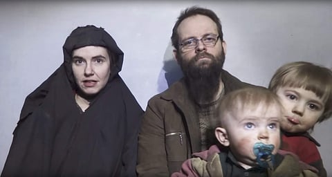 In this image from video released by Taliban Media in December 2016, Caitlan Coleman talks in the video while her Canadian husband Joshua Boyle holds their two children. | AP