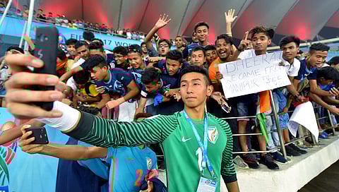 Indian goalkeeper Dheeraj Moirangthem takes selfie with his fans after U-17 FIFA World cup football match.|PTI