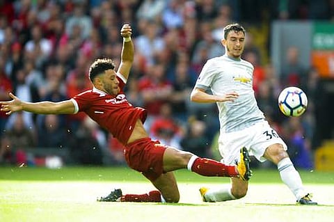 Liverpool's Alex Oxlade-Chamberlain, left, and Manchester United's Matteo Darmian, right, battle for the ball during the English Premier League soccer match between Liverpool and Manchester United at Anfield, Liverpool, England.|AP