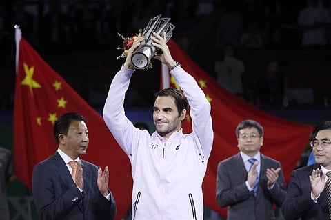 Roger Federer of Switzerland holds up his trophy after defeating Rafael Nadal of Spain in their men's singles final match to win the Shanghai Masters tennis tournament at Qizhong Forest Sports City Tennis Center in Shanghai. | AP
