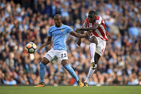 Stoke City's Kurt Zouma, right, shoots under pressure from Manchester City's Fernandinho during the EPL match. | AP