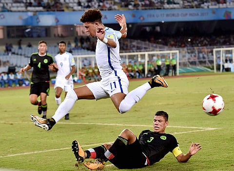 England midfielder Jadon Sancho 11 being tackled by Mexico defender Carlos Robles 3 during their FIFA U-17 World Cup football match in Kolkata. | PTI