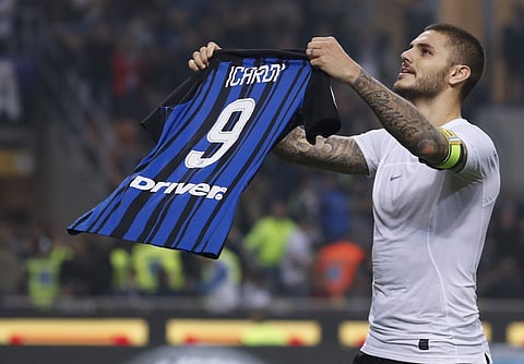 Inter Milan's Mauro Icardi shows his jersey to fans as he celebrates after scoring his 3rd goal during the Serie A soccer match against AC Milan. | AP