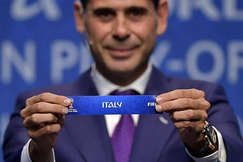 Spanish retired footballer Fernando Hierro shows the name of Italy during the FIFA football World Cup 2018 European play-off draw.|AFP