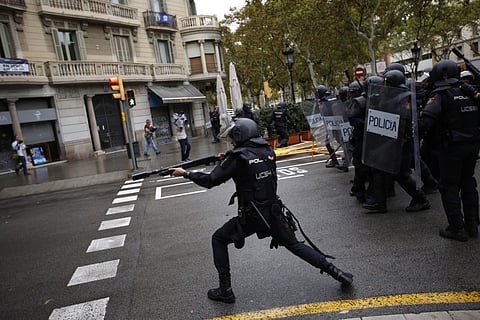 Spanish riot police shoot rubber bullet at people trying to reach a voting site at a polling station by the Catalan government in Barcelona, Spain on 1 Oct. 2017. (Photo | AP)