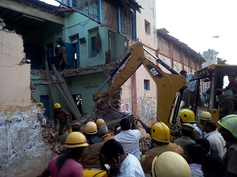 Firefighters and rescue people are removing the concrete slaps where collapse has happened in Porayar bus depot in the early Morning on Friday.(EPS)