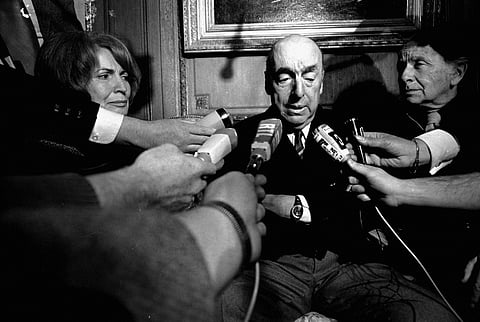 This Oct. 21, 1971 file photo shows Pablo Neruda, poet and then Chilean ambassador to France, talking with reporters in Paris after being named the 1971 Nobel Prize for Literature. (AP)