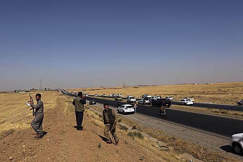 Kurdish security forces withdraw from a checkpoint in Altun Kupri, outskirts of Irbil. (Photo | AP)