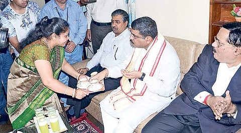 Minister for Petroleum and Natural Gas Dharmendra Pradhan at the house of a benificiary of PNG connection at Nalco Nagar, in Bhubaneswar on Friday | express