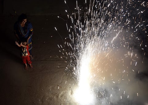 A Mother and child enjoying the Diwali Crackers in Hyderabad.