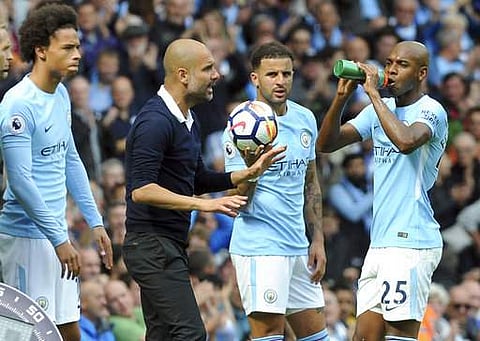 Manchester City's coach Pep Guardiola gestures as he talks to players during the EPL match. | AP