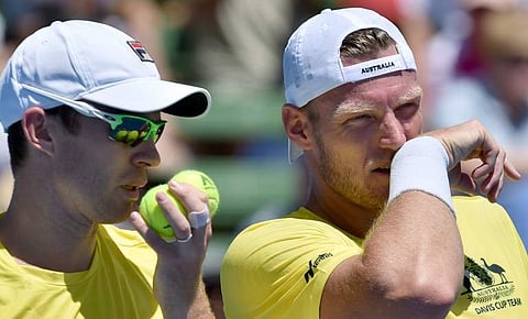Sam Groth (R) and Jon Peers (L) of Australia whisper strategies during the doubles rubber against Jiri Vesely and Jan Satral of the Czech Republic during the Davis Cup World Group at Kooyong in Melbourne. | AFP