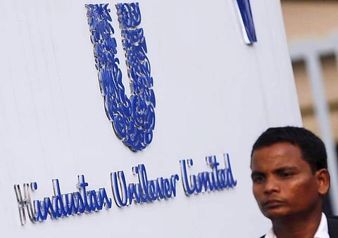 A pedestrian walks past the logo of Hindustan Unilever Limited (HUL) at its headquarters in Mumbai. (File Photo | Reuters)