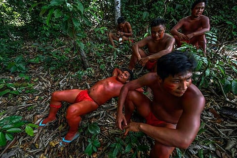 Waiapi men into the jungle in the Waiapi indigenous reserve in Amapa state in Brazil. | AFP