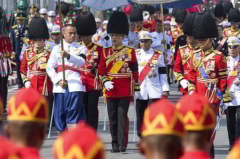Thailand's King Maha Vajiralongkorn, center, walks in funeral procession of late Thai King Bhumibol Adulyadej in Bangkok. Tearful Thais clad in black mourned on Bangkok's streets or at viewing areas around the nation as elaborate funeral ceremonies steepe