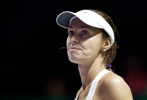 Martina Hingis of Switzerland, paired with partner Chan Yung-jan of Taiwan, reacts after conceding a point in doubles semifinal match at the WTA tennis tournament in Singapore. | AP