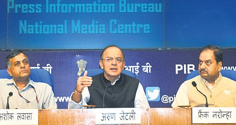 Union Minister for Finance and Corporate Affairs Arun Jaitley (centre) addressing a press conference in New Delhi