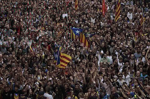 Protesters demonstrate outside the National police headquarters during a one-day strike in Barcelona. (Photo | AP)
