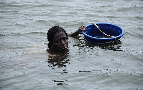 Hundreds of women have lost their jobs in Kerala as traditional coir weaving succumbed to mechanisation and stiff competition from other states backed by better marketing. Despite the high quality of the coir produced in the Chirayinkeezhu and its adjoining vast areas, the sun has set on the industry. (In pic: Nalini a woman diver searches for clams in the Kadinamkulam backwaters. | B P Deepu)