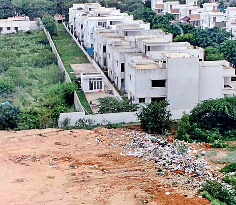 A disputed open land near Alpine Viva apartment has turned into a dumping ground, causing huge inconvenience to the residents