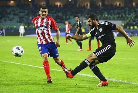 Atletico Madrid's Angel Correa, left, with Qarabag's Rashad Sadygov during the Champions League, group C, soccer match between Qarabag FK and Atletico Madrid at the Baku Oliympiy stadium. | AP