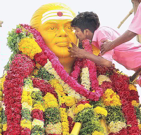 A youth kissing the Thevar statue at Goripalayam Junction, in Madurai on Monday | K K Sundar
