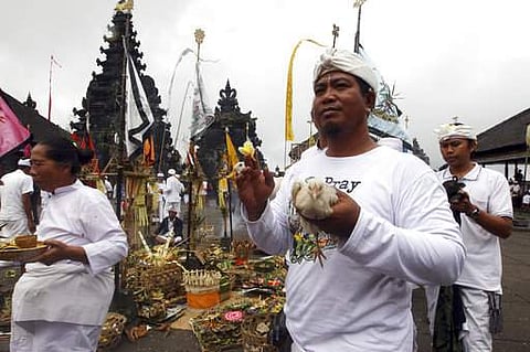 Balinese men carry animal for offering during a ceremony at Besakih temple which is located few kilometers from the crater of Mount Agung volcano in Karangasem, Bali, Indonesia.|AP
