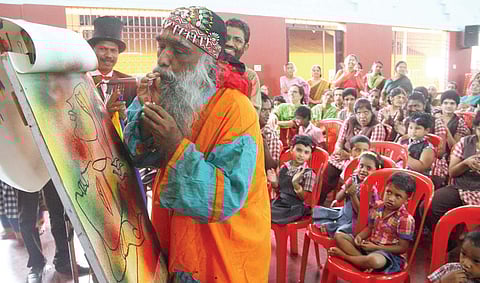 Artist T Kaladharan giving children painting tips during a class organised by Ernakulam Women’s Association Hall as part of Gandhi Jayanti celebrations on Wednesday | Melton Antony