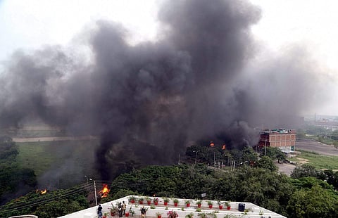 Smoke billows from Panchkula, a residential area which saw violence erupt after Dera chief Ram Rahim Singh was convicted in a rape case. (File Photo | PTI)