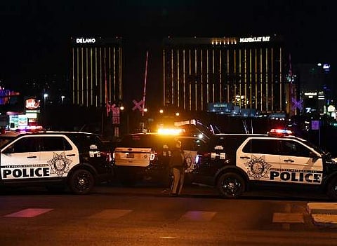 Police form a perimeter around the road leading to the Mandalay Hotel (background) after a gunman killed at least 58 people at a country music concert in Las Vegas, Nevada on October 2, 2017. (File Photo | AFP)