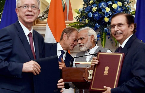Prime Minister Narendra Modi and Donald Franciszek Tusk President of the European Council witness signing of an agreement between India and EU at Hyderabad House in New Delhi on Friday. (PTI Photo)