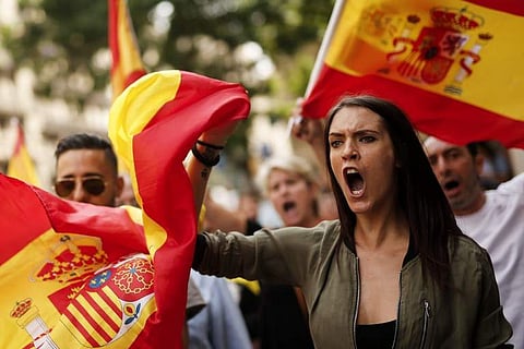 Protestors hold Spanish flags during a demonstration against independence in Catalonia (File |AFP)