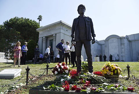 Guests gather around a statue of the late actor Anton Yelchin during a life celebration and statue unveiling for Yelchin at Hollywood Forever Cemetery on Sunday, Oct. 8, 2017, in Los Angeles. Yelchin died in June 2016 at the age of 27. | AP