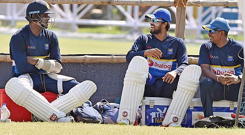 Sri Lanka captain Dinesh Chandimal shares a light moments with his teammates Angelo Mathews (L) and Rangana Herath (R)during their training session. | PTI